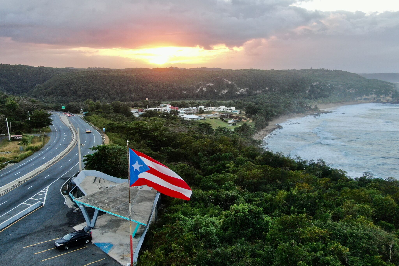 Scenic coastal view of Piñones with Puerto Rican flag overlooking the shoreline